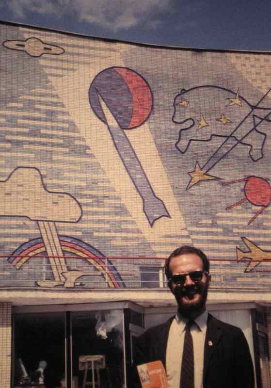 photo of Bill Hunter in front of colorful mosaic building front in Moscow