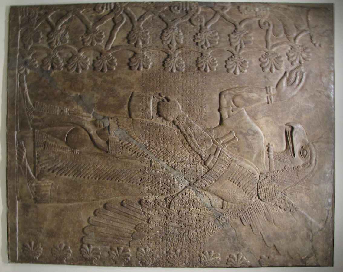 photo of Assyrian relief carving of an eagle-headed demon