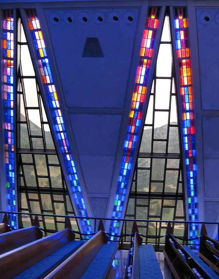 photo of view inside Cadet Chapel USAF Academy looking through windows to mountains.